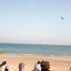 People watch as Franky Zapata, a 40-year-old inventor, takes to the air in Sangatte, Northern France, at the start of his attempt to cross the channel from France to England Thursday July 25, 2019